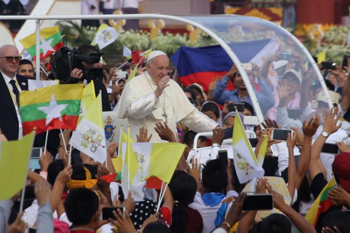 Pope Francis arrives to lead the Holy mass as faithfuls wave Myanmar and Vatican City flags at Kyaikkasan ground in Yangon on 29 November 2017. Photo: Thet Ko/Mizzima
