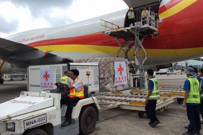 Airport staff unloading H1N1 vaccines donated by PRC from a cargo plane at Yangon International Airport. Photo: MNA
