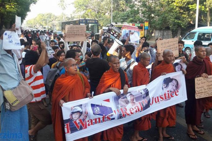 Buddhist monks and people hold placards and shout slogans during a protest against death sentence for two Myanmar migrant workers in Yangon on 26 December 2015. Photo: Thet Ko/Mizzima
