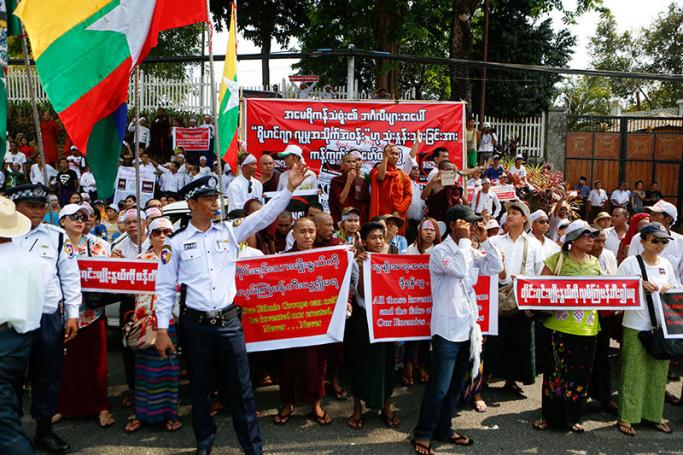 Buddhist monks and nationalists hold flags and placards in front of the US embassy during an unauthorised demonstration against the use of 'Rohingyas' in Yangon, Myanmar, 28 April 2016. Photo: Lynn Bo Bo/EPA
