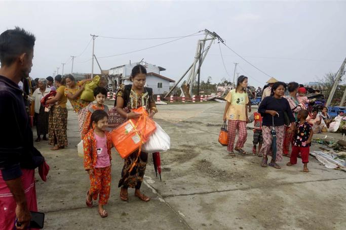(File) People bring their belongings as they walk amid the debris after cyclone Mocha made landfall in Sittwe, Rakhine State, Myanmar, 15 May 2023. Photo: EPA