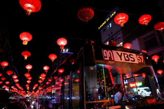 A bus drives along a road decorated with lighted up red lanterns in celebrations for the Chinese Lunar New Year or Spring Festival at chinatown in Yangon, Myanmar, 14 February 2018. Photo: Lynn Bo Bo/EPA-EFE
