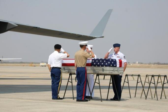 A US military honor guard salutes a coffin carrying suspected remains of American airmen killed in Myanmar during World War II (AFP Photo)