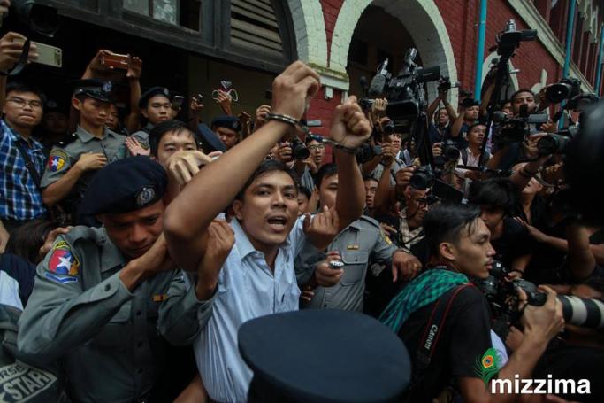 Reuters journalist Kyaw Soe Oo (C) is escorted out of the Insein township court in Yangon on 03 September 2018. Photo: Thura/EPA