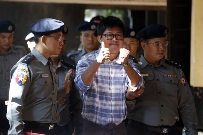 Reuters journalist Wa Lone (C) is escorted by police as he arrives to the court in Yangon, Myanmar, 23 January 2018. Photo: Nyein Chan Naing/EPA-EFE

