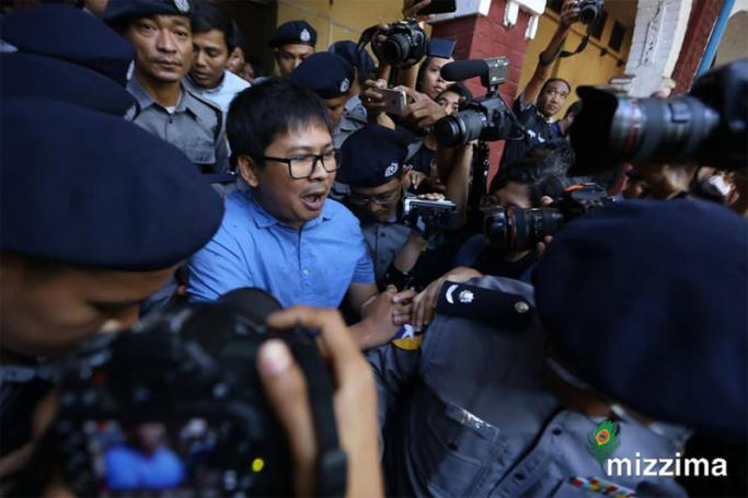 Reuters journalists Wa Lone (C, front) and Kyaw Soe Oo (C, back) are escorted by police as they leave the court after their trial in Yangon on 10 January 2018. Photo: Thet Ko/Mizzima
