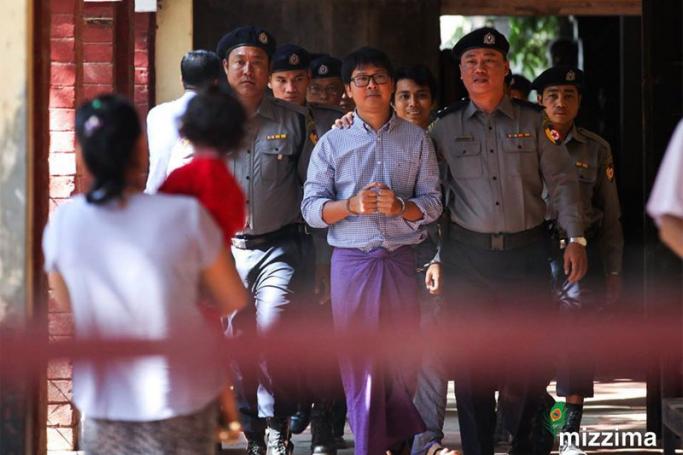 Detained Reuters journalist Wa Lone (C) is escorted by police as he arrives to the court for a hearing in Yangon on 01 February 2018. Photo: Thura/Mizzima
