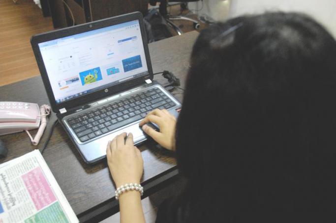 A Myanmar girl surfs the internet in Yangon. Photo: Htet Khaung Linn/Myanmar Now
