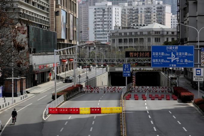 This photo taken on March 15, 2020 shows barriers set up to block off a street in Wuhan, in China's central Hubei province. Photo: AFP