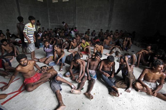 Rohingya and Bangladeshis men inside the refugees camp at Kuala Langsa, Aceh, Indonesia, 15 May 2015. According to reports, more than 600 Rohingya and Bangladeshis landed at Kuala Langsa Port, Aceh, Indonesia. Photo: Jun Ha/EPA
