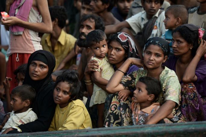 (File) Rohingya migrants sit on a boat drifting in Thai waters off the southern island of Koh Lipe in the Andaman sea on May 14, 2015. Photo: AFP
