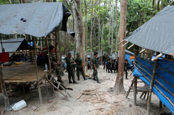 Thai soldiers secure the area next to shelters after discovering another abandoned jungle camp believed used by the human traffickers to detain Rohingya migrants at a mountain in Sadao, Thai-Malaysian border district, Songkhla province, southern Thailand, 12 May 2015. Photo: EPA
