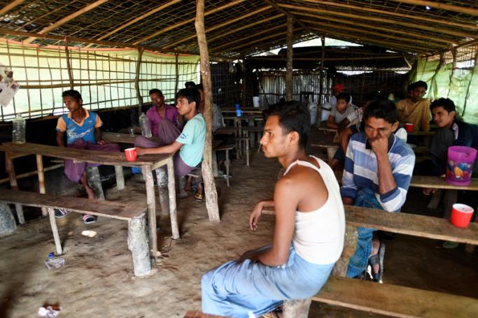 Rohingya men watch a Hindi romance film at a makeshift cafe in the Jamtoli refugee camp near Cox's Bazar, Bangladesh, 12 December 2017. Photo: EPA-EFE
