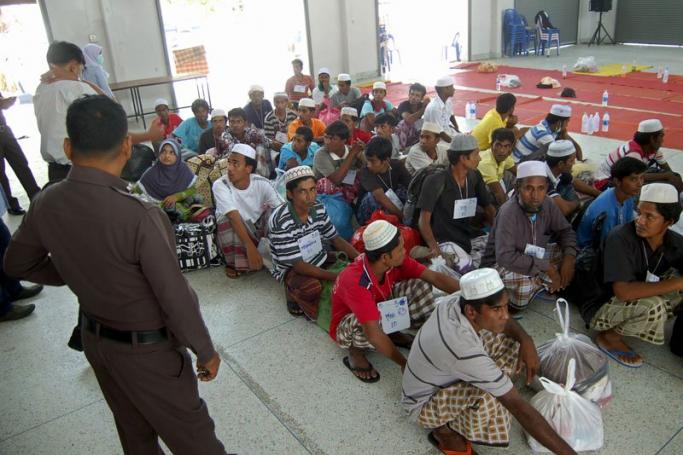 Thai policeman and immigration officials check Muslim migrants from Bangladesh, days after they were rescued along with ethnic Rohingya refugees following the human trafficking crackdown, at the district hall in Rattaphum district, Songkhla province southern Thailand, 12 May 2015.  EPA/PHUCHISS 
