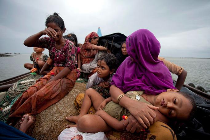 (File) Rohingya Muslim women and children sit in a boat after they were intercepted by the Bangladesh Border Guard (BGB) members in Teknaf, Bangladesh, 13 June 2012. Photo: EPA
