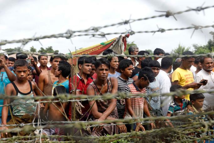 (FILE) - Rohingya refugees gather near a fence at the 'no man's land' zone at the Bangladesh-Myanmar border in Maungdaw district, Rakhine State, western Myanmar, 24 August 2018. Photo: Nyein Chan Naing/EPA