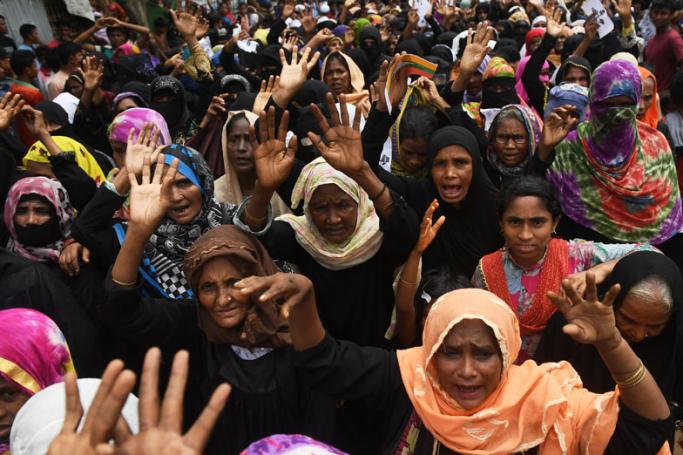 Rohingya refugees shout slogans during a protest march after attending a ceremony to remember the first anniversary of a military crackdown that prompted a massive exodus of people from Myanmar to Bangladesh, at the Kutupalong refugee camp in Ukhia on August 25, 2018. Photo: Dibyangshu Sarkar/AFP