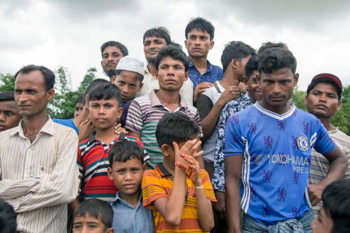 Rohingya refugees stands in front of UN and Bangladesh refugee commission office at Shalbagan repartition camp, during the repartition day in Teknuf, Cox’s Bazar, Bangladesh, 22 August 2019. Photo: Suman Paul/EPA