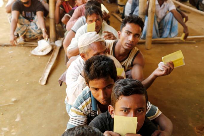 (File) Newly arrived Rohingya refugees wait for relief goods inside the UNHCR distribution point at the newly extended camps Kutupalong in UKhiya, Cox's Bazar, Bangladesh, 12 February 2018. Photo: Abir Abdullah/EPA-EFE
