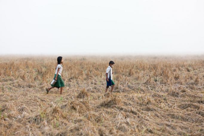 Khee Khee Phown, left, on the long walk to her rural school. Photo: Hong Sar/Mizzima
