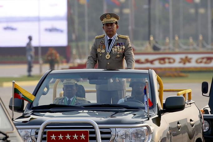 Senior General Min Aung Hlaing (C), Commander in Chief of the Myanmar Army, is transported in the back of a military vehicle as he inspects troops during the 72nd Armed Forces Day in Naypyitaw, Myanmar, 27 March 2017. Photo: Nyein Chan Naing/EPA
