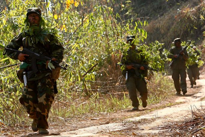 A group of camouflaged SSA (Shan State Army) guerrillas on patrol near the rebel jungle stronghold of Doi Tailang in Myanmar's Shan state. Photo: Rungroj Yongrit/EPA