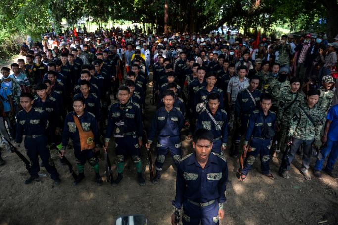 Anti-coup fighters sing a revolution song as they escort protesters during a demonstration against the military coup in Sagaing Township in the Sagaing Division of Myanmar on September 7, 2022. Photo: AFP
