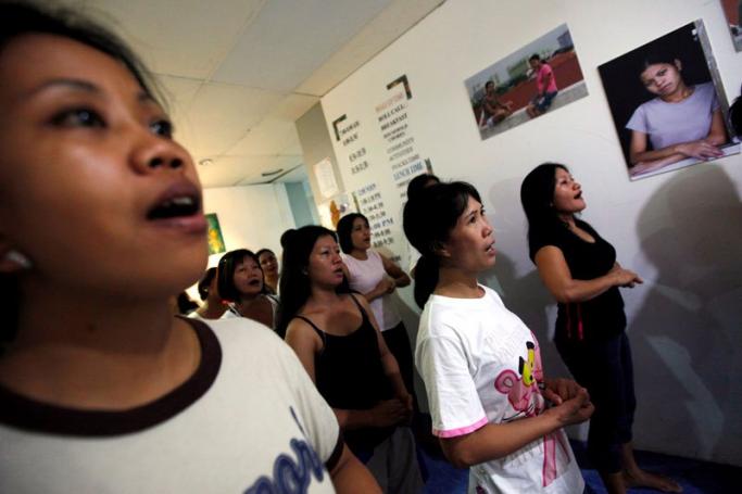 Foreign domestic workers practice during singing lessons in a shelter for foreign maids run by the Humanitarian Organization for Migration Economics (HOME) in Singapore. Photo: EPA

