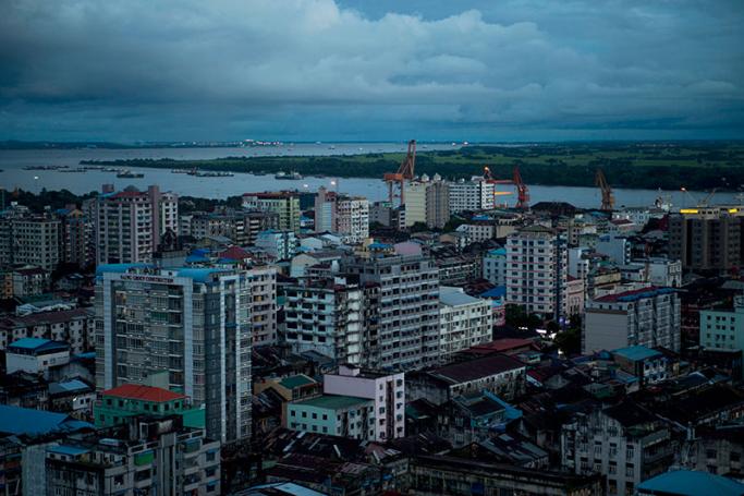 Old and new buldings are seen over the skyline of Yangon with a view of Yangon river in the background. Photo: Romeo Gacad/AFP
