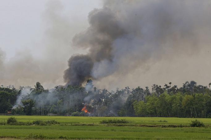 Smoke and flames rise from the Gawdu Thara village in Maungdaw township, Rakhine State, western Myanmar, 07 September 2017. Photo: Nyein Chan Naing/EPA
