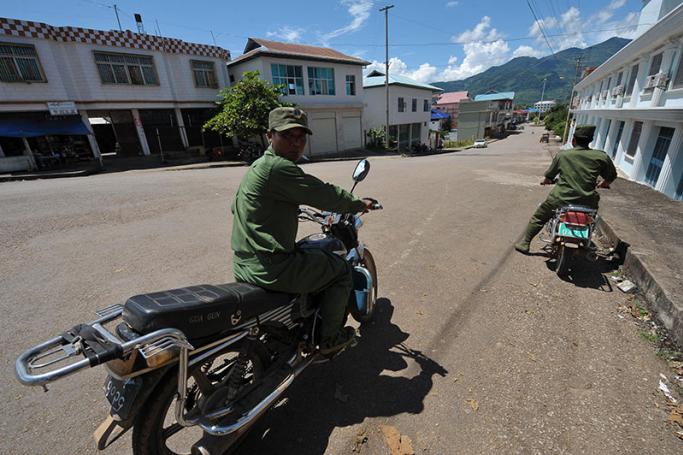 Soldiers from the United Wa State Army patrol the near deserted streets of Nandeng in the Wa region of Myanmar. Photo: AFP
