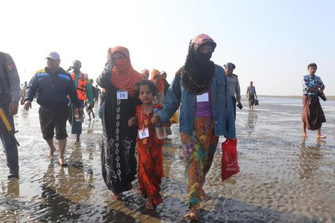 (File) Rohingya people who were arrested at sea in December walk on a beach after being transported by Myanmar authorities to Thalchaung near Sittwe in Rakhine state on January 13, 2020. Photo: AFP