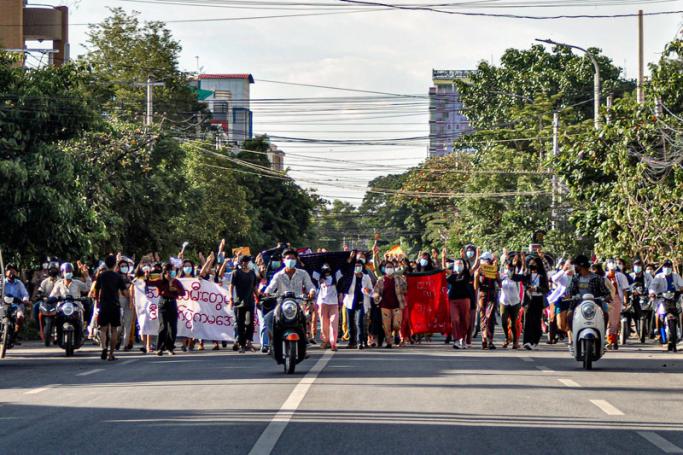 Women protesters make the three-finger salute as they take part in a demonstration against the military coup in Mandalay on July 10, 2021.  Photo: AFP