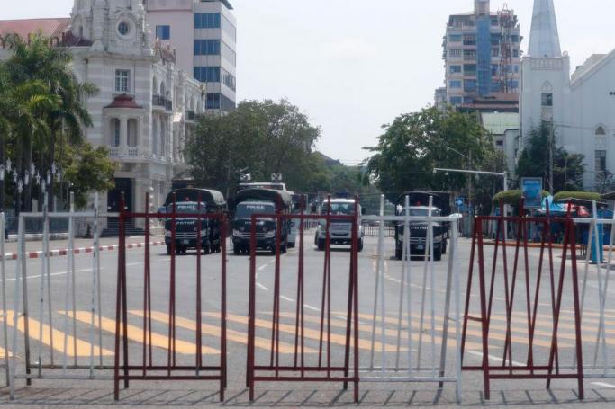 (File) Police trucks are parked and block the road in front of the City Hall in Yangon, Myanmar, 13 April 2021. Photo: EPA