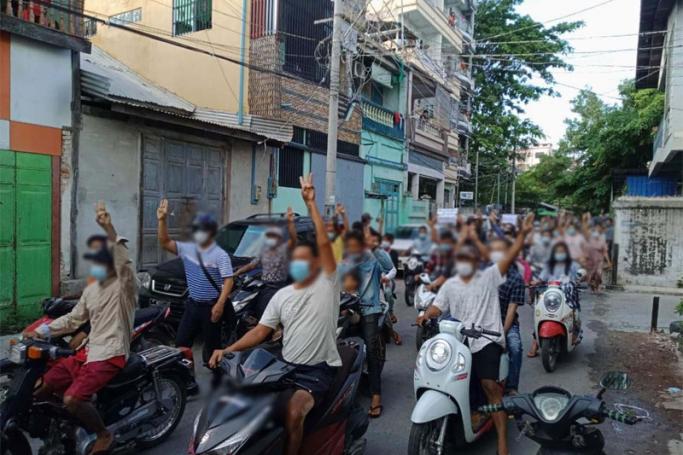 Demonstrators flash three-finger salute during an anti-military coup protest in Mandalay on 5 June, 2021. Photo: CJ