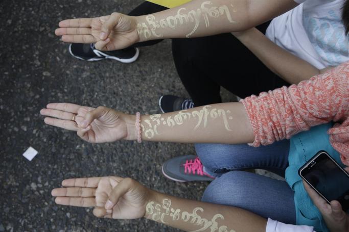 (File) Demonstrator girls with Thanakha, a yellowish-white traditional cosmetic paste made from a tree bark, applied to their hands with the words reading’ Spring revolution’ as they flash three-fingers salutes during a protest against the military coup, in Yangon, Myanmar, 25 February 2021. Photo: EPA