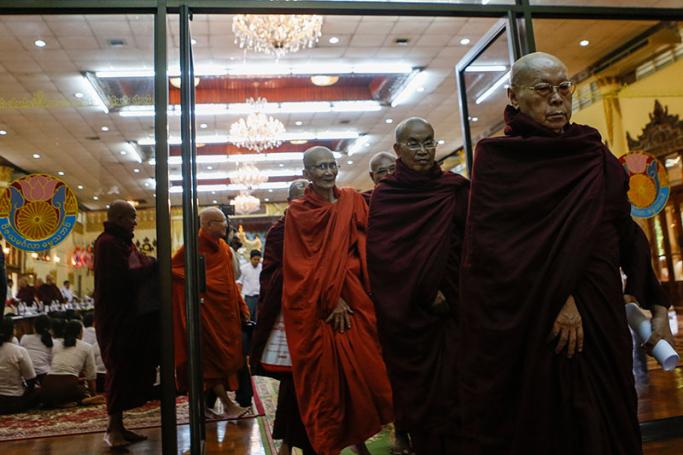Members of the State Sangha Maha Nayaka Committee (State Buddhist Authority) leave a conference room after the committee members meeting in Yangon, Myanmar, 13 July 2016. Photo: Lynn Bo Bo/EPA
