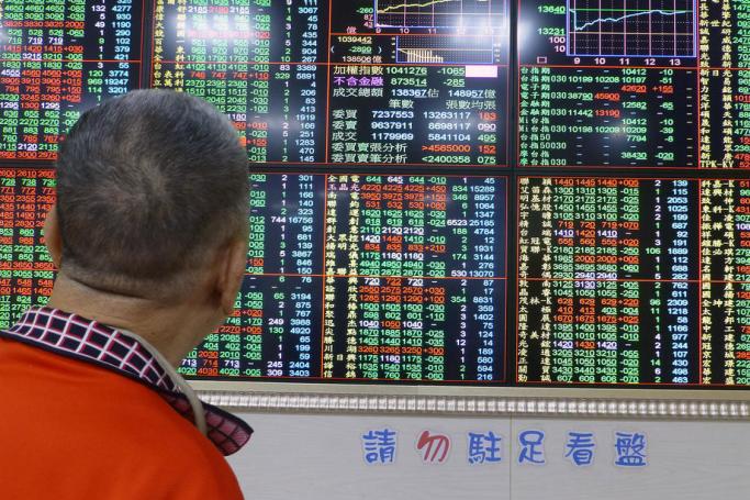 A man watches a monitor at a stock exchange in Taipei, Taiwan. Photo: David Chang/EPA