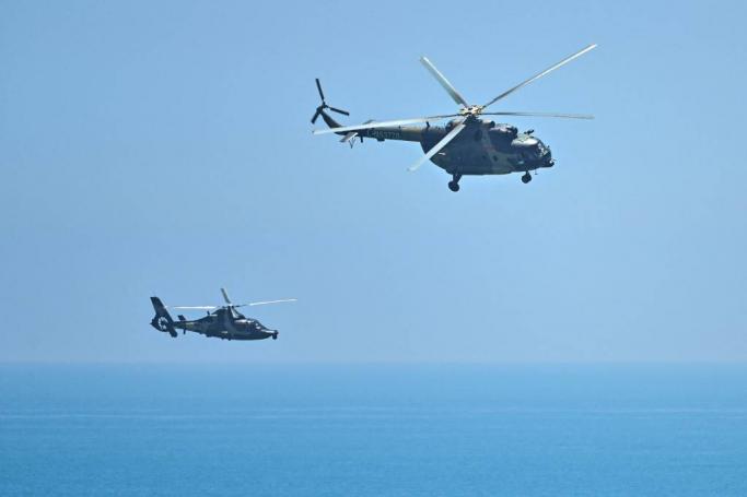 Chinese military helicopters fly past Pingtan island, one of mainland China’s closest point from Taiwan, in Fujian province on August 4, 2022, ahead of massive military drills off Taiwan following US House Speaker Nancy Pelosi’s visit to the self-ruled island. China’s largest-ever military exercises encircling Taiwan kicked off on August 4, in a show of force straddling vital international shipping lanes after a visit to the island by US House Speaker Nancy Pelosi. Photo: AFP
