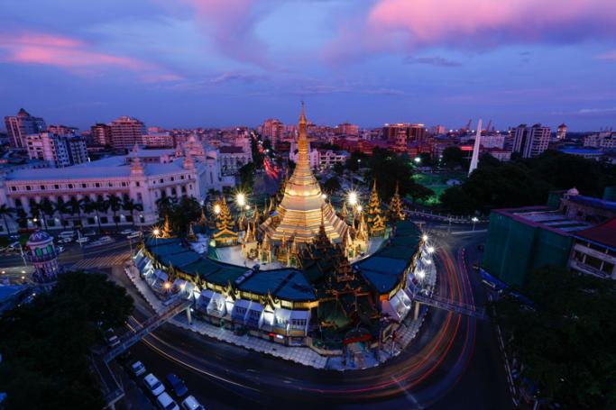 A photo taken with a long exposure shows a general view of the Sule pagoda and the city skyline during twilight in Yangon, Myanmar. Photo: Lynn Bo Bo/EPA-EFE
