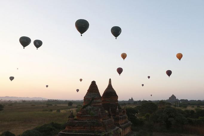 Balloons carrying visitors fly at sunrise over old temples of the ancient temple city of Bagan, Mandalay Region, Myanmar, 25 January 2017. Photo: Hein Htet/EPA
