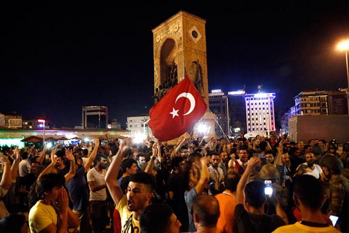 Supporters of President of Turkey Recep Tayyip Erdogan shout slogans at the Taksim Square in Istanbul, Turkey, 16 July 2016. Turkish Prime Minister Yildirim reportedly said that the Turkish military was involved in an attempted coup d'etat. The Turkish military meanwhile stated it had taken over control. Photo: Sedat Suna/EPA
