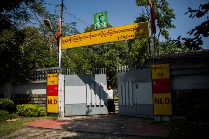 A man closes a gate leading to the residence of Myanmar's leader Aung San Suu Kyi in Yangon on February 1, 2018, after a petrol bomb was hurled into the compound. Photo: Ye Aung Thu/AFP
