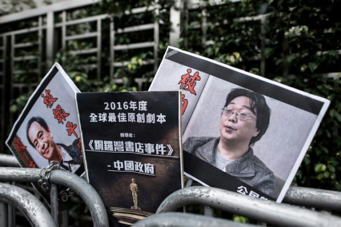Gui Minhai (R), one of five Hong Kong-based booksellers known for publishing salacious titles about Chinese political leaders, was snatched by Chinese authorities while on a train to Beijing in February 2018 (AFP/File / Philippe LOPEZ)