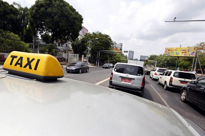 A taxi stops at the traffic light on Pyay road in Yangon, Myanmar. Photo: Nyein Chan Naing/EPA

