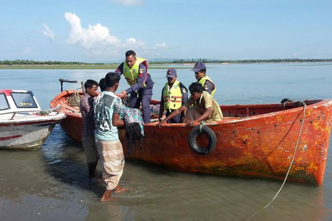 Bangladesh coastguard hand over recovered bodies to local Bangladeshi locals after recovering it from the Naf river estuary near Shah Porir Dwip in Teknaf on October 16, 2017. Photo: Jashim Mahmud/AFP
