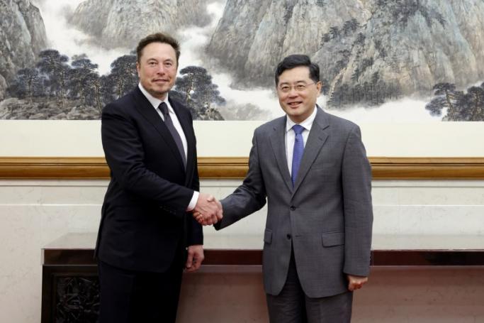 A handout photo released by the Ministry of Foreign Affairs of the People's Republic of China shows Tesla CEO Elon Musk (L) shaking hands with China's Foreign Minister Qin Gang during a meeting in Beijing, China, 30 May 2023. Photo: EPA