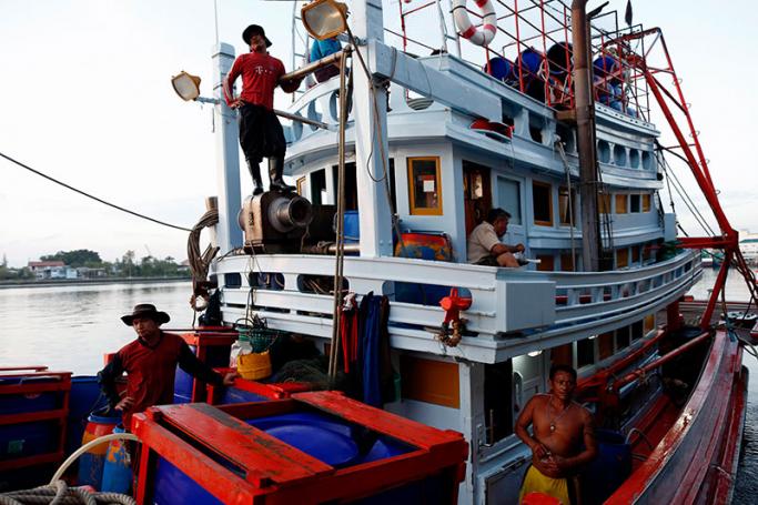 Thai and migrant fishermen from Myanmar on a Thai fishing boat after loading fish at a jetty in Samut Sakhon province, Thailand, 19 January 2016. Photo: Rungroj Yongrit/EPA
