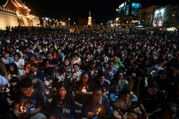People gather for a candlelight vigil in Nakhon Ratchasima, Thailand, following a mass shooting which Prime Minister Prayut Chan-O-Cha called unprecedented (AFP PHOTO/ CHALINEE THIRASUPA)