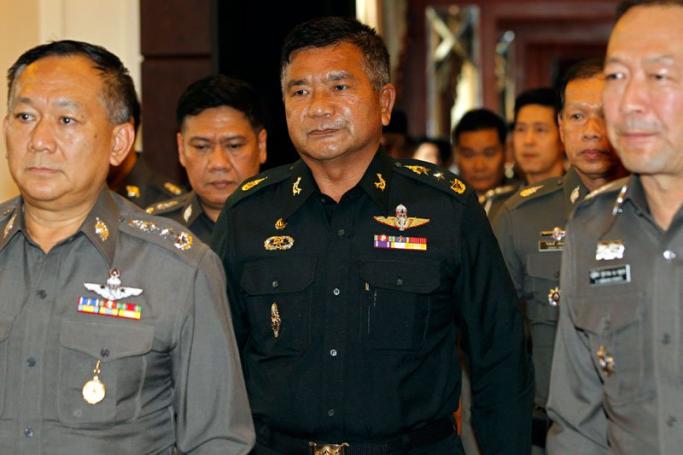 Thai Senior Army Advisor Lieutenant General Manas Kongpan (C), who is allegedly involved in human trafficking of Rohingya migrants, is escorted by police officers as he turns himself in at the Royal Thai Police headquarters in Bangkok, Thailand, 03 June 2015. Photo:  Rungroj Yongrit/EPA
